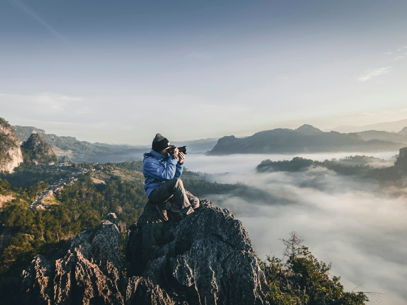 A creator photographing a mountain landscape
